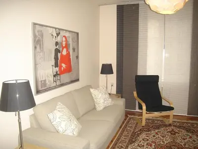 a living room with a couch and a chair at Bulhotel Pritzker Apartment in Sofia