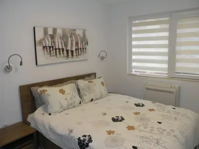 a bedroom with a bed and a window at ApArt apartments in Plovdiv
