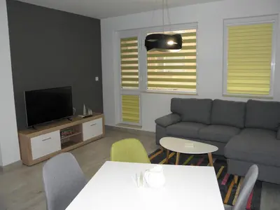 a living room with a couch and a tv at ApArt apartments in Plovdiv