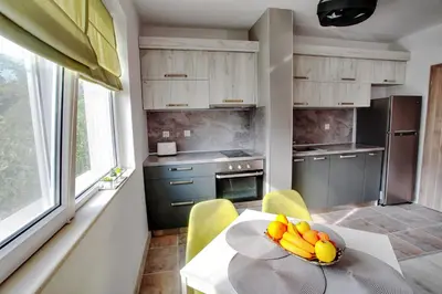 a kitchen with a table with a bowl of fruit on it at ApArt apartments in Plovdiv