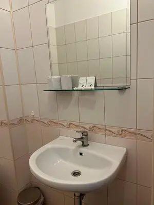 a bathroom with a sink and a mirror at Apartment August 11 in Sofia