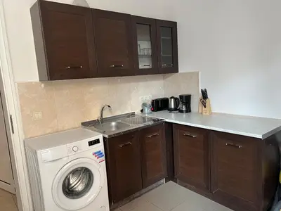 a kitchen with a washing machine and a sink at Apartment August 11 in Sofia