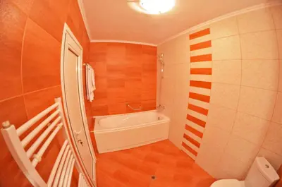 a small bathroom with a tub and a sink at Central West Hotel in Sofia