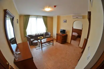 a living room with a couch and a table at Central West Hotel in Sofia
