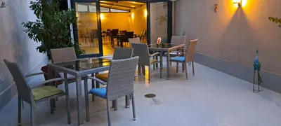 a dining room with a table and chairs and a table and chairsktop at Central West Hotel in Sofia