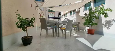 a table and chairs on the side of a building at Central West Hotel in Sofia