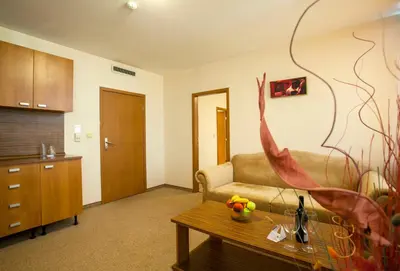 a living room with a couch and a table at Hotel Intelcoop in Plovdiv