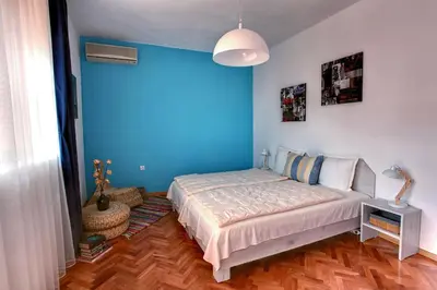 a bedroom with a bed and a blue wall at TERRACE HOME - Three bedrooms City center in Plovdiv