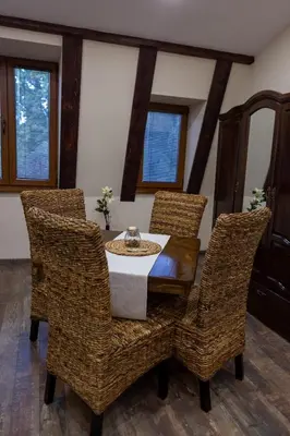 a dining room with a table and wicker chairs at Central Loft in Plovdiv