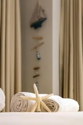 a towel with a starfish sitting on a table in front of a mirror at Luxury Central Apartment in Plovdiv