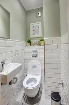 a white bathroom with a toilet and a sink at Spacious flat close to the American Embassy, free parking place in Sofia