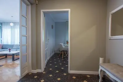 a hallway with a door leading to a living room at Spacious flat close to the American Embassy, free parking place in Sofia