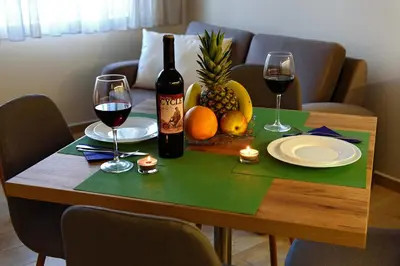 a table with two glasses of wine and fruit on it at Apartment Iris in Plovdiv