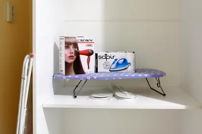 a shelf in a bathroom with a magazine and a telephone at Apartment Iris in Plovdiv