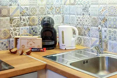 a kitchen counter with a sink and a coffee maker at Apartment Iris in Plovdiv