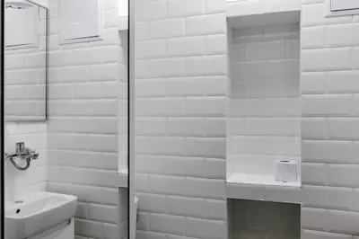 a white bathroom with a sink and a shower at Vinyl Studio Apartment Sofia in Sofia