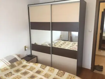a bedroom with a large mirror over a bed at Belvedere holiday apartment in Bansko
