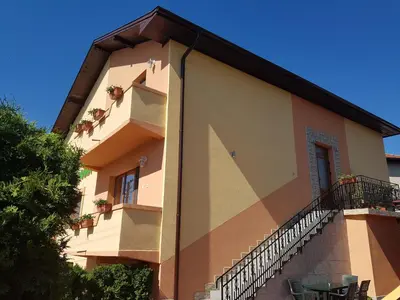 a building with a balcony and a table in front of it at Family Hotel Dalia in Velingrad