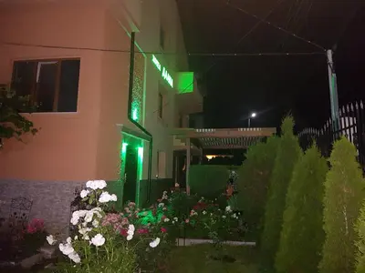 a building with flowers in front of it at night at Family Hotel Dalia in Velingrad