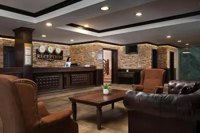a lobby with a waiting room with a table and chairs at Royal Park Hotel by Astoria Collection in Bansko