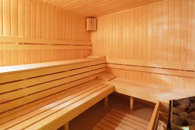 a wooden sauna with wooden benches in it at Royal Park Hotel by Astoria Collection in Bansko