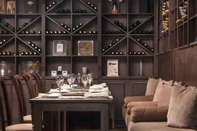 a dining room with a table with wine glasses at Royal Park Hotel by Astoria Collection in Bansko