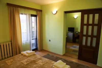 a bedroom with a bed with two towels on it at Къща за гости Типик in Bansko
