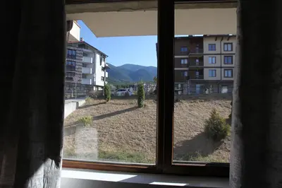 an open window with a view of a building at Snow Pearl Residence & FREE SPA in Bansko