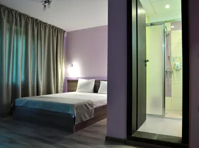 a bedroom with a bed and a glass shower at Visito Aparthouse in Sofia