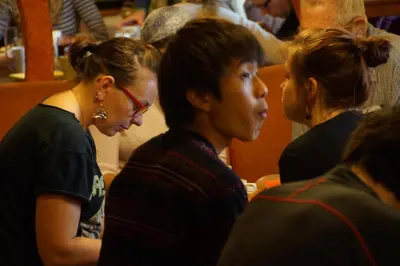 a group of people sitting at a table at Hostel Mostel Hub Rooms and Apartments in Sofia