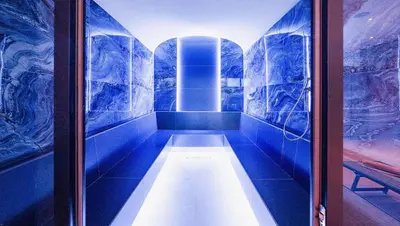 a sauna with blue tiled walls at Predela 2 Aparthotel in Bansko