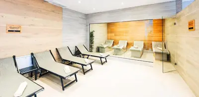 a waiting room with tables and chairs and a mirror at Predela 2 Aparthotel in Bansko