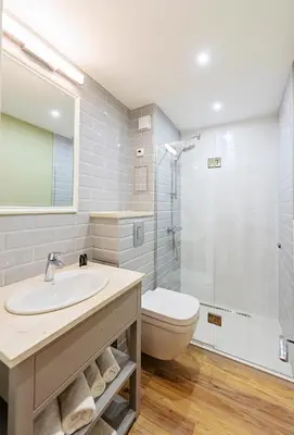 a bathroom with a sink and a toilet and a shower at Predela 2 Aparthotel in Bansko
