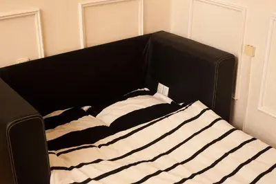 a black and white bed in a room at Botev Apartment in Sofia