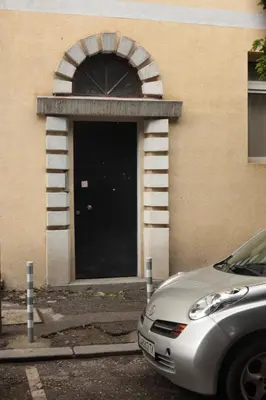 a car parked in front of a building with a door at Botev Apartment in Sofia