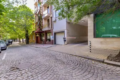 a cobblestone street in a city with buildings at The M Place by Flat Mаnager in Sofia