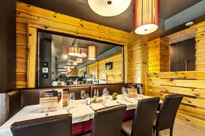 a dining room with a long table and chairs at 3 Mountains Hotel in Bansko