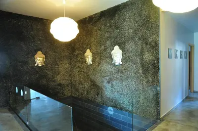 a lobby with a black wall with lights on it at 3 Mountains Hotel in Bansko