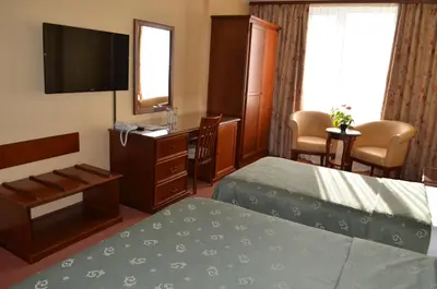 a hotel room with a bed and a flat screen tv at Hotel Bankya Palace in Bankya