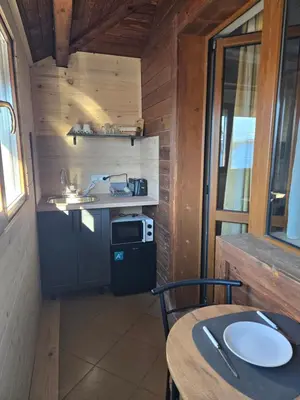 a small kitchen with a stove and a table at Pirina Club Hotel in Bansko