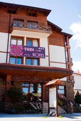 a building with a sign for a hotel at Pirina Club Hotel in Bansko