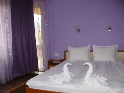 two swans carved out of a bed in a bedroom at Kashta Peychevi in Govedartsi
