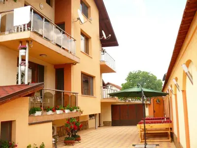 a building with an outdoor patio with an umbrella at Kashta Peychevi in Govedartsi
