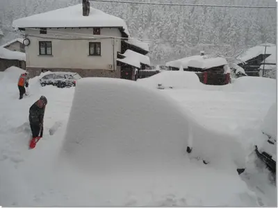 a pile of snow in front of a house at Family hotel Iskar in Govedartsi