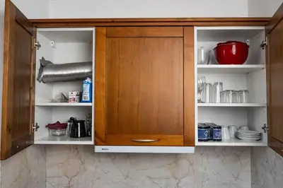 a cupboard with a wooden door in a kitchen at St. John Hill Apartment, Bansko in Bansko