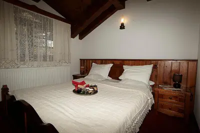 a bedroom with a bed with a bowl on it at Family hotel Makedonska Kruchma in Dobrinishte