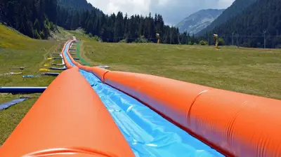 an orange and blue pipe on the side of a field at Guesthouse Pumpalovi in Dobrinishte