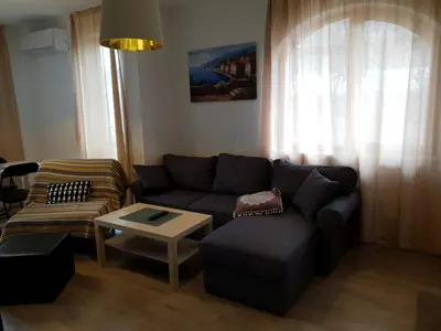 a living room with a couch and a coffee table at St. Seraphim's Apartment in Sofia