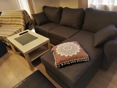 a living room with a couch and a table at St. Seraphim's Apartment in Sofia