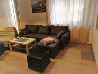 a living room with a couch and a table at St. Seraphim's Apartment in Sofia